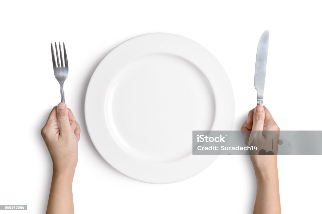White plate with silver fork and spoon Dinner place setting. A white plate with silver fork and spoon isolated on white background with clipping path Plate Stock Photo