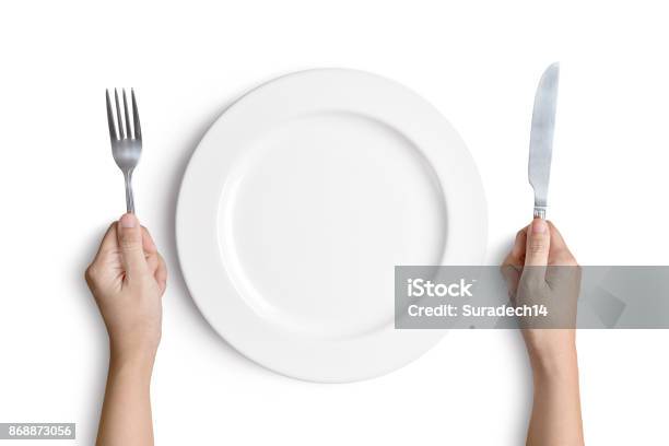 White Plate With Silver Fork And Spoon Stock Photo - Download Image Now - Plate, Hand, Fork