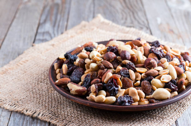 istock Mixed nuts on a plate on wooden background 868876754