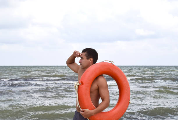 istock The man on the beach with a lifebuoy 868877342
