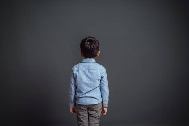 Little child in front of dark background