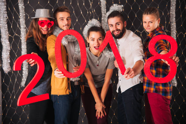 istock Young excited friends welcoming the new 2018 868880708