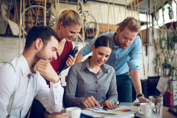 istock Young business people cooperating and brainstorming during coffee break. 868883940