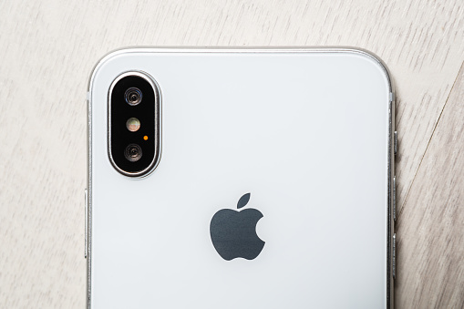 Latest Apple Iphone 10 smart phone in close up.Trendy new Iphone X device with dual photo camera and big infinity edge touch screen