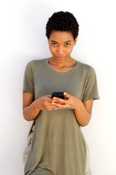 istock cool young black woman holding mobile phone 868887974