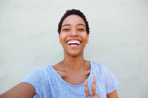 istock happy smiling young african woman taking selfie 868888160