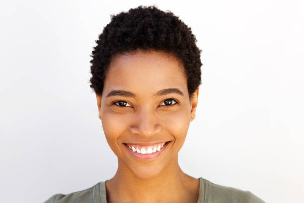 istock Close up beautiful young black woman smiling against white wall 868888232