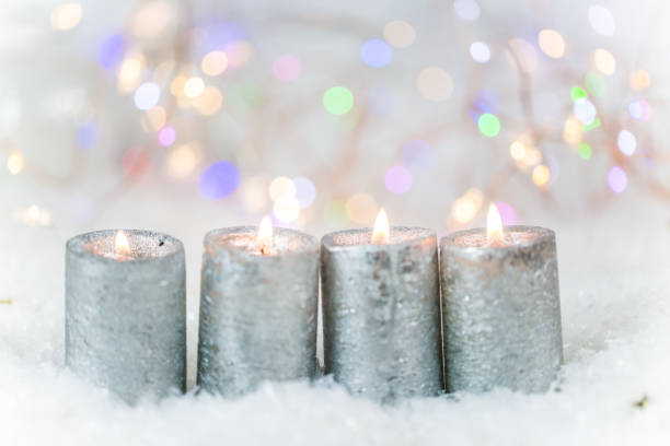 istock Candles in the snow, lights in the background 868891946