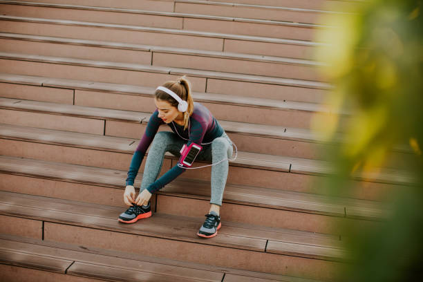 istock Attractive female runner taking break after jogging outdoors 868892322