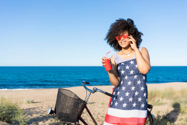 istock Woman with american flag drinking red cocktail 868896174