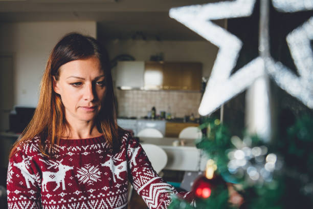 istock Woman decorating christmas tree 868899574