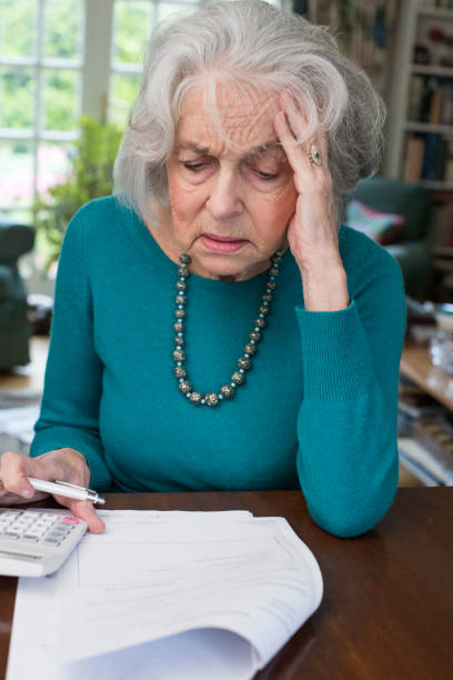 istock Senior Woman Going Through Bills And Looking Worried 868900542
