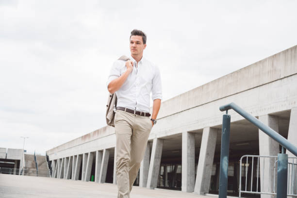 istock Handsome young businessman walking in the street from work 868904050