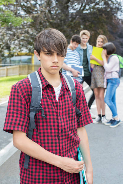 istock Unhappy Boy Being Gossiped About By School Friends 868904202