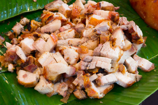 istock Close up Thai roasted crispy pork on banana leaf 868904426