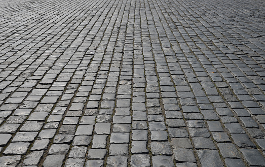 Abstract background. Old cobblestone pavement close-up.