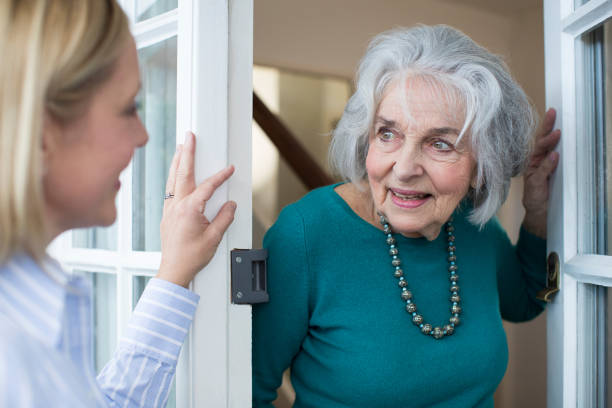 istock Woman Checking On Elderly Female Neighbor 868904482