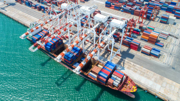 istock container,container ship in import export and business logistic,By crane,Trade Port , Shipping,cargo to harbor.Aerial view,Water transport,International,Shell Marine,transportation,logistic,trade,port 868906210