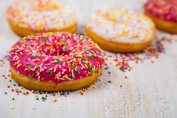 istock Multicolored donuts  on a wooden background. 868907822