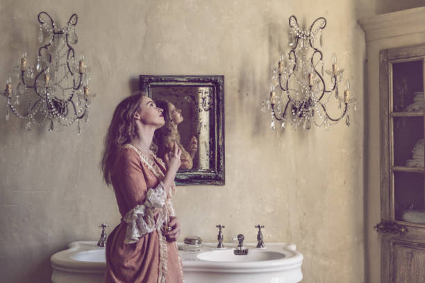 18th century woman in a castle 18th centure woman in a castle applying perfume mirror women baroque style fashion stock pictures, royalty-free photos & images