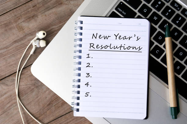 New Year's Resolutions List on Notepad Laptop,Earphone, Diary, Letter, List, Pen new year resolution stock pictures, royalty-free photos & images