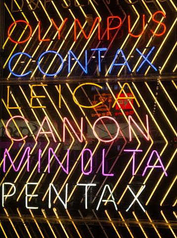 Hong Kong, China - A neon sign featuring a variety of camera brands on the exterior of a photography equipment store in Mong Kok, Kowloon.