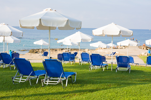Sunbeds and umbrellas on public beach in Paphos, Cyprus