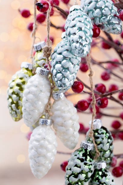 istock Christmas cone with red berries on a bokeh background. 868919780