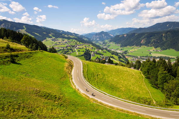 istock Cyclists in valley with Schladming town in Styria, Austria 868919910
