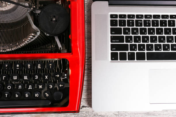 istock Old typewriter maschine and laptop on table. Concept of technology progress 868920200