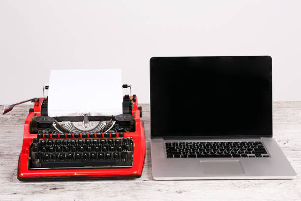 istock Old typewriter maschine and laptop on table. Concept of technology progress 868920264