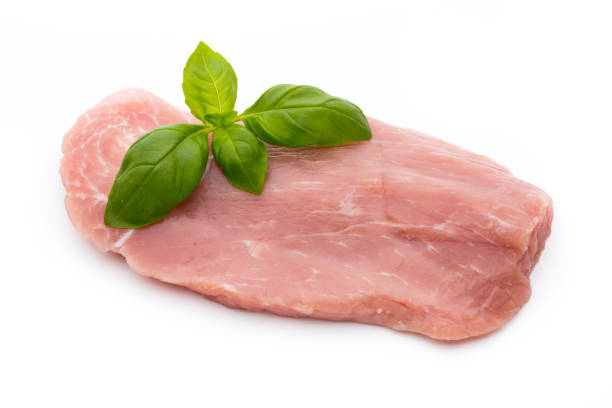 istock Fresh pork fillet with basil on a white background. 868922724