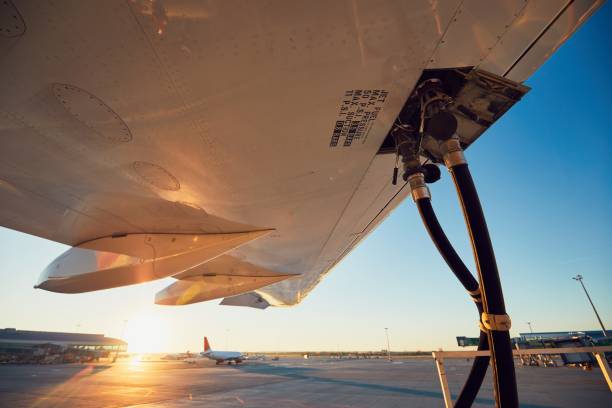 Refueling of the airplane Amazing sunset at the airport. Refueling of the airplane before flight. air vehicle stock pictures, royalty-free photos & images