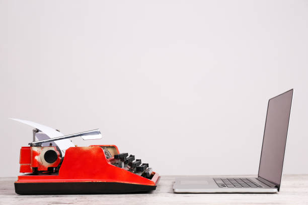 istock Old typewriter and laptop on table. Concept of technology progress 868922928