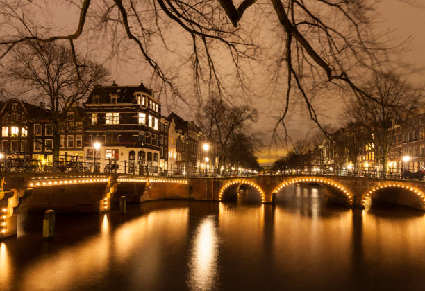 istock Amsterdam city canals illuminated at night 868922968