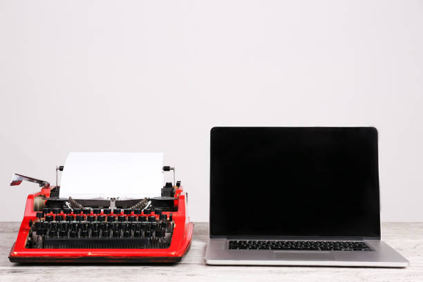 istock Old typewriter and laptop on table. Concept of technology progress 868923158