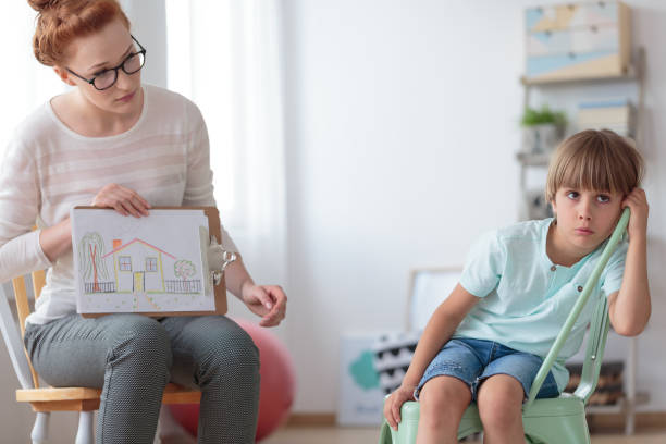istock Adoption counselor and little boy 868923312
