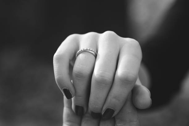 istock Close Up Holding Hands with Engagement Ring 868923886