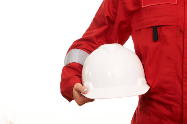 Woman construction worker holds helmet in hand