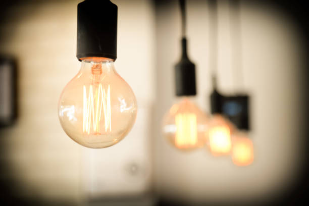 istock light bulbs against wall background.retro luxury light lamp glowing.Restaurant modern interior light bulbs 868927144