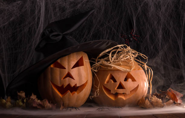 istock Two halloween pumpkins and spiders in the smoke 868927648