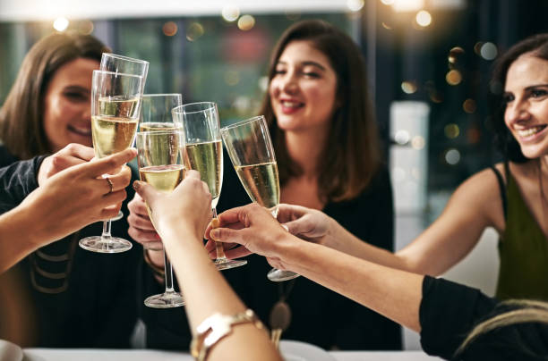 To many more nights like these Cropped shot of a group of young girlfriends toasting during a dinner party at a restaurant ladies night stock pictures, royalty-free photos & images