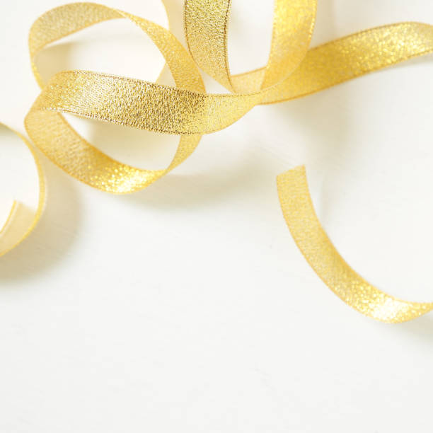 istock Curly gold ribbon isolated on white background 868936008
