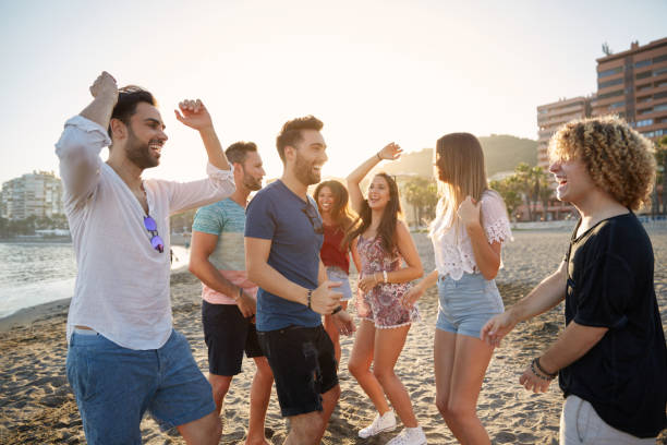 istock Young happy people partying on beach 868942752