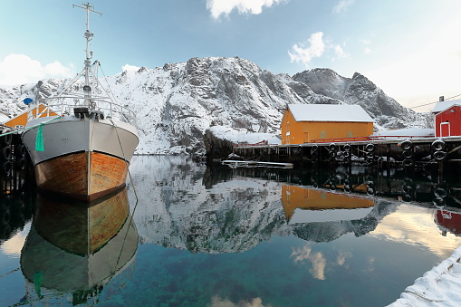 Old wooden fishing boat moored-snow covered harbor-Nusfjord fishing village. Flakstadoya-Lofoten-Norway.0494