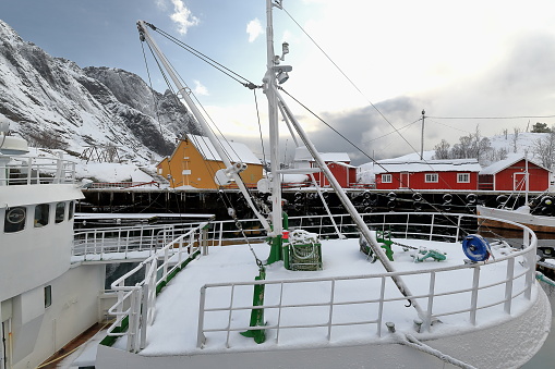 Old wooden fishing boats moored-snow covered harbor-Nusfjord fishing village. Flakstadoya-Lofoten-Norway.0497