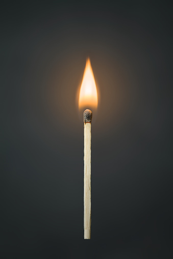 A small stack of matchsticks in the lower right corner on a white background