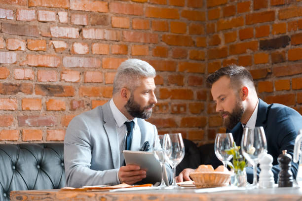 istock Two businessmen having lunch in the pub 868950654