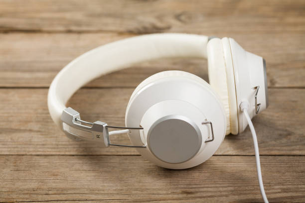 istock White headphones on old wooden table 868950658