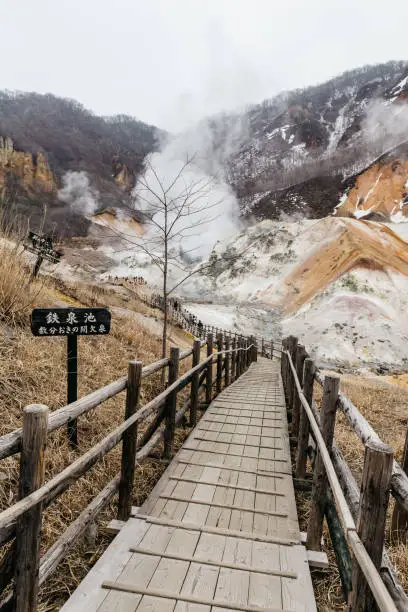 Photo of Wood structure walk way of Noboribetsu Jigokudani (Hell Valley): The volcano valley got its name from the sulfuric smell, extremely high heat and steam spouting out of the ground in Hokkaido, Japan.